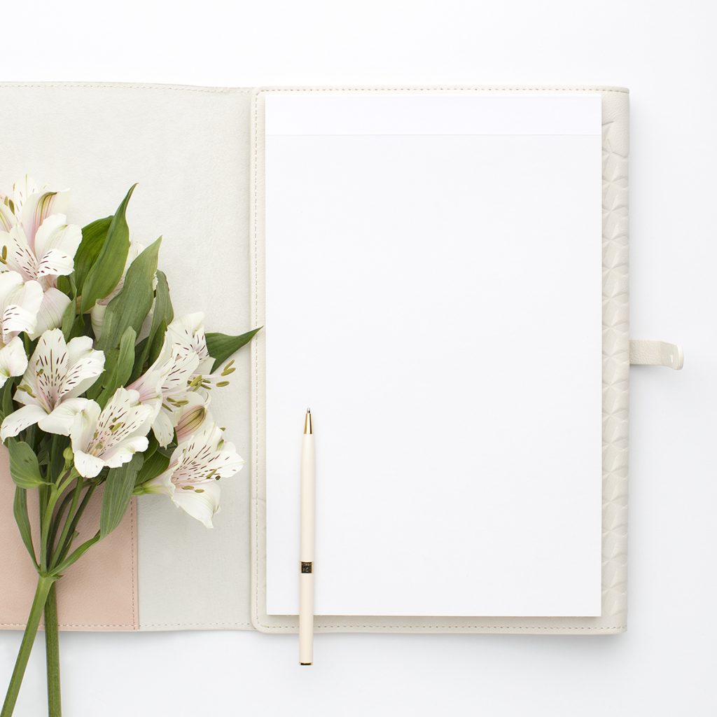 a flat lay of a journal spread open with some flowers